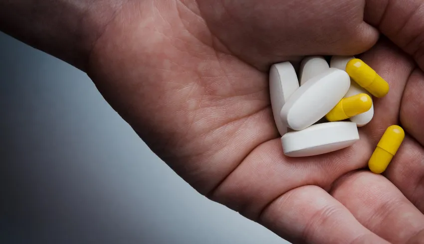 hand holding pills family member needs help
